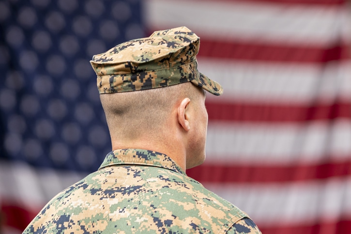 Soldier looking towards US Flag